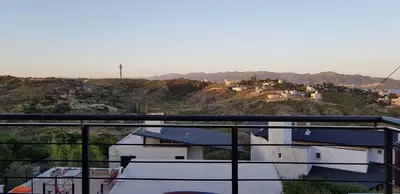 a view of a city from a balcony at Vivaldi Suites in Villa Carlos Paz