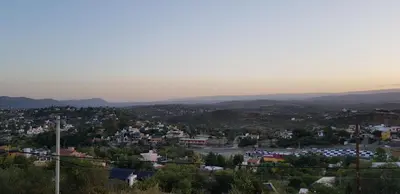 a view of a town with mountains in the distance at Vivaldi Suites in Villa Carlos Paz