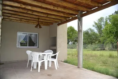 a patio with white chairs and a table on a porch at A Dolce Vita in Nono