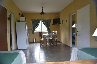 a kitchen and dining room with a table and a refrigerator at A Dolce Vita in Nono