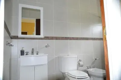 a white bathroom with a toilet and a sink at A Dolce Vita in Nono