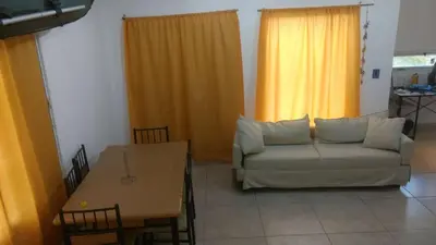 a living room with a couch and a table at La Casa de Patis in Villa Carlos Paz