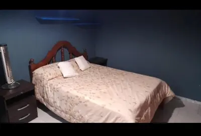 a bedroom with a bed with two pillows on it at La Casa de Patis in Villa Carlos Paz