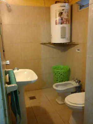 a small bathroom with a toilet and a sink at Casa de Silvia in Villa Carlos Paz