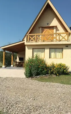 a house with a balcony on top of it at Brujas in Los Reartes