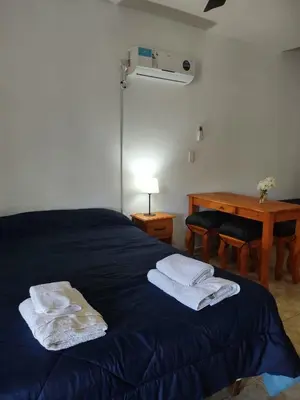 a bedroom with a blue bed with towels on it at Finca La Julia in Luyaba