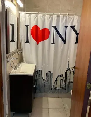 a bathroom with a red heart on the shower curtain at Ganesha in Villa Carlos Paz
