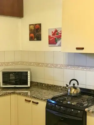 a kitchen with a stove and a tea kettle at Ganesha in Villa Carlos Paz