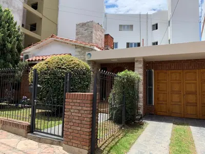 a house with a gate and a building at Ganesha in Villa Carlos Paz