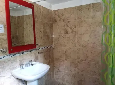 a bathroom with a sink and a mirror at Malvina in Villa Icho Cruz