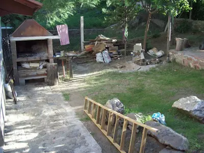 a backyard with a wooden fence and a grill at Malvina in Villa Icho Cruz