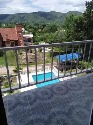 a view from the balcony of a house with a swimming pool at Malvina in Villa Icho Cruz