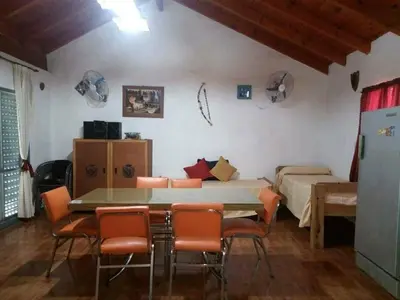 a room with a table and chairs and a bedroom at Malvina in Villa Icho Cruz