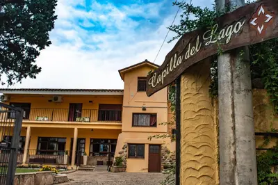 a sign for a hotel in front of a building at Capilla del Lago in Villa Carlos Paz