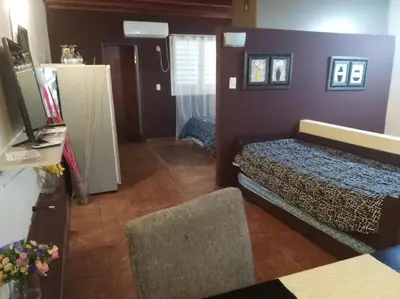 a small room with a bed and a television at Apartamento Nuevo Centro in Cordoba
