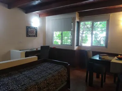 a bedroom with a bed and a table and window at Apartamento Nuevo Centro in Cordoba