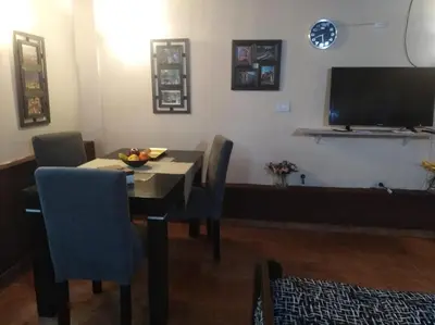 a dining room with a table and a television at Apartamento Nuevo Centro in Cordoba