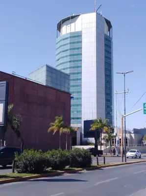 a tall glass building in front of a street at Apartamento Nuevo Centro in Cordoba