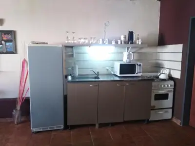 a small kitchen with a microwave and a refrigerator at Apartamento Nuevo Centro in Cordoba