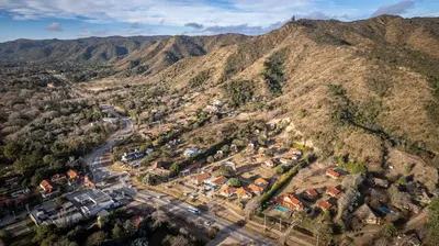 an aerial view of a village on a mountain at Harmonie Hotel De Montaña - Adults only in Villa General Belgrano