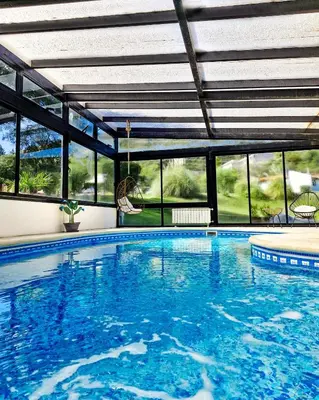 a large swimming pool with a large group of windows at Harmonie Hotel De Montaña - Adults only in Villa General Belgrano