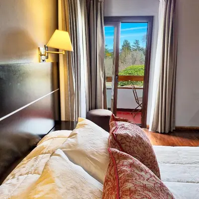 a bedroom with a bed with a view of a balcony at Harmonie Hotel De Montaña - Adults only in Villa General Belgrano