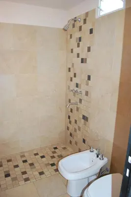 a bathroom with a toilet and a sink at Apart Hotel El Portico in Villa Carlos Paz