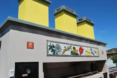 a building with two yellow towers on top at Apart Hotel El Portico in Villa Carlos Paz