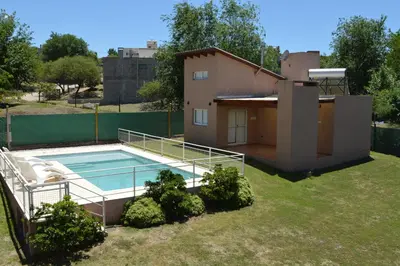 a house with a swimming pool in the yard at Kawsay Complejo de Cabañas in San Antonio de Arredondo