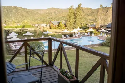 a view from the balcony of a resort with a pool at Chamonix Posada & Spa in Villa General Belgrano