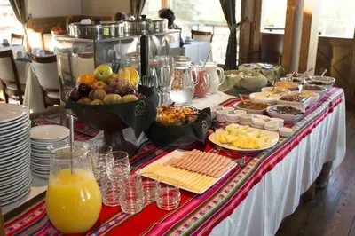a buffet of food and drinks on a table at Chamonix Posada & Spa in Villa General Belgrano