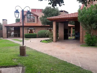 a brick house with a street light in front of it at Cabañas La Aldea in Villa Carlos Paz