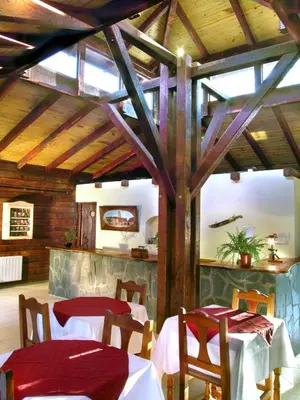 a dining room with two tables and a counter at Posada Pfullendorf - Adults Only in Villa General Belgrano