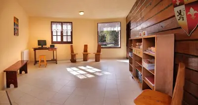 a living room with a table and a desk with chairs at Posada Pfullendorf - Adults Only in Villa General Belgrano