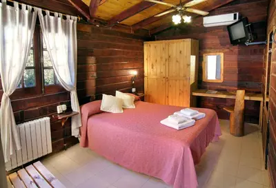 a bedroom with a pink bed with towels on it at Posada Pfullendorf - Adults Only in Villa General Belgrano