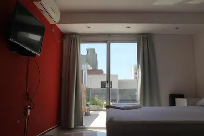 a bedroom with a bed and a window with a view at Link Cordoba Hostel in Cordoba