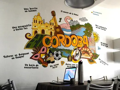 a wall with a mural ofcorona on it at Link Cordoba Hostel in Cordoba