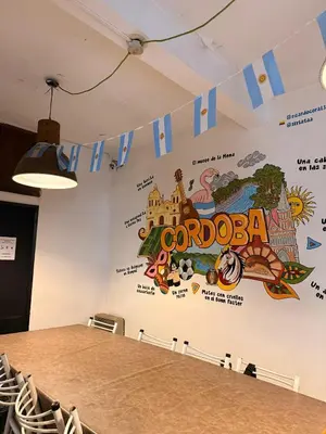 a conference room with a large mural on the wall at Link Cordoba Hostel in Cordoba