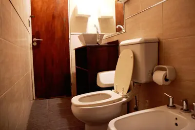 a small bathroom with a toilet and a sink at Link Cordoba Hostel in Cordoba