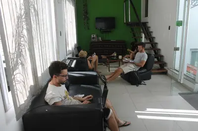 a group of people sitting in chairs in a room at Link Cordoba Hostel in Cordoba