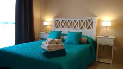 a bedroom with a bed with towels on it at Merlo Centro Aparts in Merlo