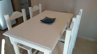 a white table and chairs with a bowl on it at Merlo Centro Aparts in Merlo