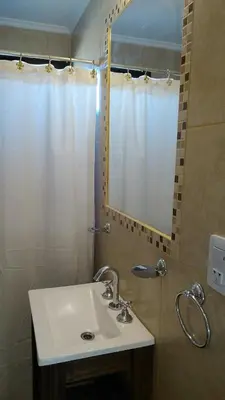 a bathroom with a sink and a mirror at Merlo Centro Aparts in Merlo