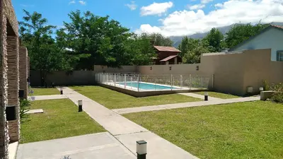 a swimming pool in the backyard of a house at Merlo Centro Aparts in Merlo