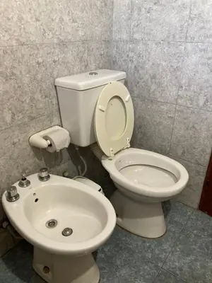 a bathroom with a toilet and a sink at Aires de las Sierras in Villa Carlos Paz