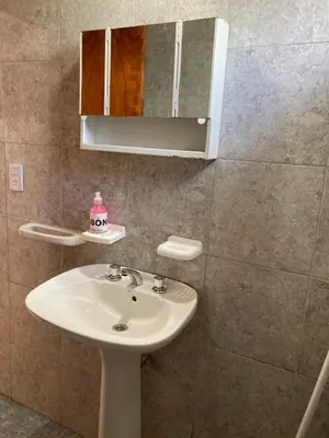 a bathroom with a sink and a mirror at Aires de las Sierras in Villa Carlos Paz