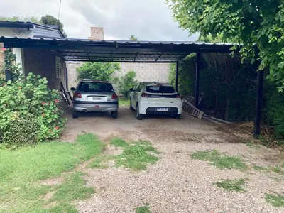 two cars are parked in a garage at Aires de las Sierras in Villa Carlos Paz