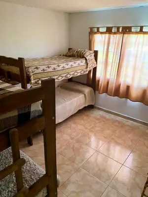 a room with two bunk beds and a window at Aires de las Sierras in Villa Carlos Paz