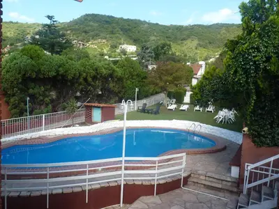 a swimming pool with a view of a mountain at Hotel Aoma Villa Carlos Paz in Villa Carlos Paz