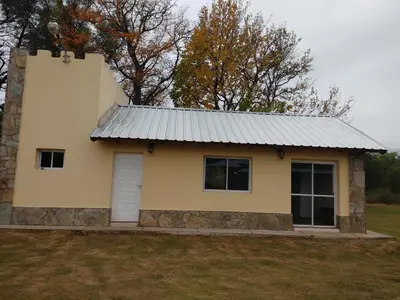 a small yellow house with a metal roof at Cabañas Misky Wayra in San Francisco del Monte de Oro
